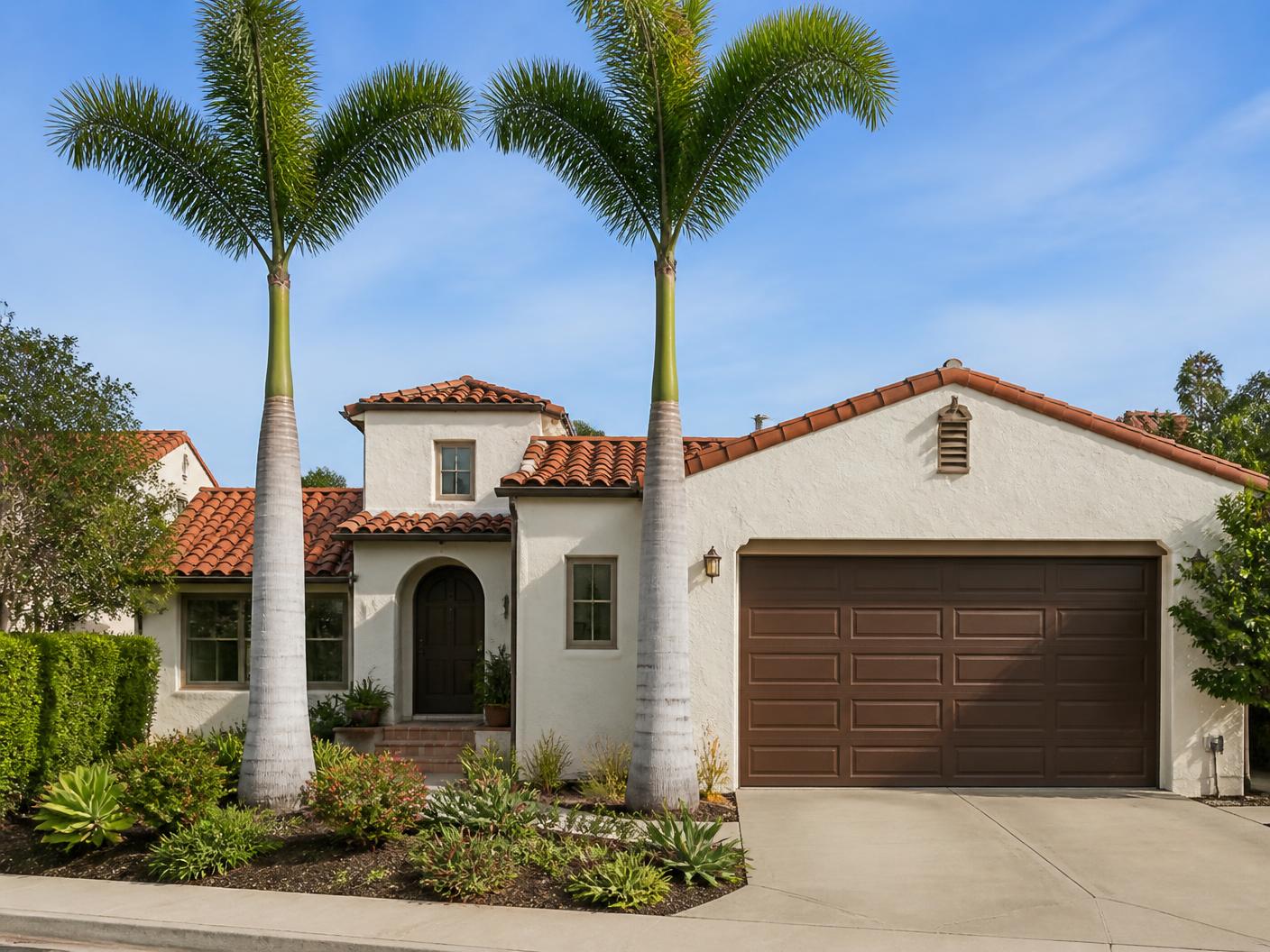 Freshly cleaned queen palms in front of a Chula Vista home